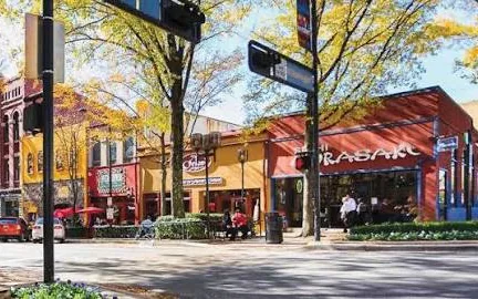 Storefronts along a tree-lined street in downtown Greenville, South Carolina